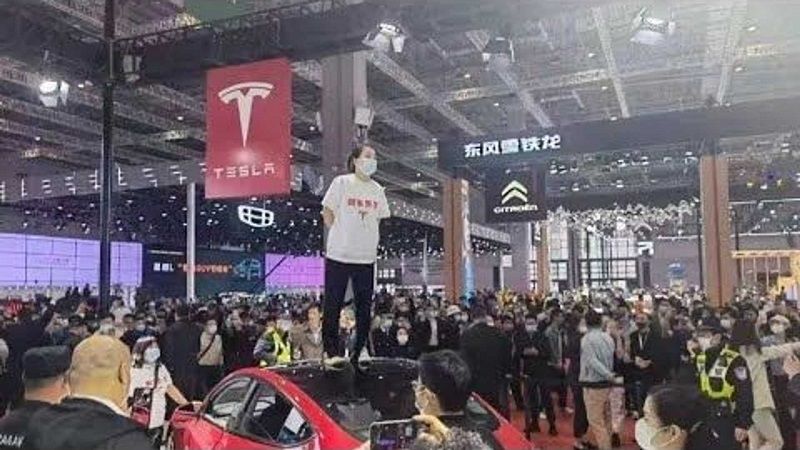shanghai auto show woman on tesla roof